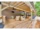 Expansive outdoor patio with a ceiling fan and wooden deck with a kitchen prep area at 3447 Filbert Hwy, Clover, SC 29710