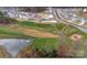 Aerial view of the neighborhood community, featuring a pond, recreation area, and neatly planned homes at 347 Carolina Hemlock Dr, Locust, NC 28097