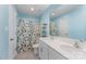 Comfortable bathroom featuring a double sink vanity and a shower with floral print curtain at 347 Carolina Hemlock Dr, Locust, NC 28097