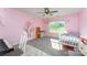 Bright bedroom features pink walls, a ceiling fan, and ample natural light at 347 Carolina Hemlock Dr, Locust, NC 28097