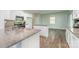 Modern kitchen with white cabinets, granite counters, and stainless appliances at 347 Carolina Hemlock Dr, Locust, NC 28097