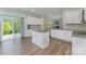 Open kitchen with white cabinets, granite counters, island, and stainless appliances at 347 Carolina Hemlock Dr, Locust, NC 28097