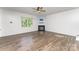 Spacious living room with wood-look floors, fireplace, and large windows at 347 Carolina Hemlock Dr, Locust, NC 28097