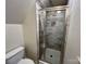 Updated bathroom featuring a sleek, glass-enclosed shower with modern fixtures at 5111 Clearwater Rd, Charlotte, NC 28217