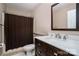 Bathroom features a dark wood vanity, a white countertop, and a shower with curtain at 5111 Clearwater Rd, Charlotte, NC 28217