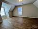 Bright bedroom features wood-look flooring, natural light, and neutral paint at 5111 Clearwater Rd, Charlotte, NC 28217