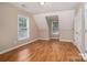 Bright bedroom with hardwood floors, neutral walls, and natural light from the windows at 5111 Clearwater Rd, Charlotte, NC 28217