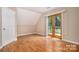 Bedroom with hardwood floors, neutral walls, and natural light from the doors at 5111 Clearwater Rd, Charlotte, NC 28217