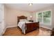 Bedroom with hardwood floors, neutral walls, and natural light from the window at 5111 Clearwater Rd, Charlotte, NC 28217