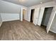 Large bedroom featuring wood-look flooring and closet space at 5111 Clearwater Rd, Charlotte, NC 28217