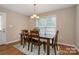 Comfortable dining room with hardwood floors, table, chairs, and a pleasant window view at 5111 Clearwater Rd, Charlotte, NC 28217
