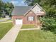 Attractive home with a brick exterior, attached garage, and well-maintained lawn at 5111 Clearwater Rd, Charlotte, NC 28217