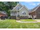Attractive house with a landscaped lawn, covered front porch, and two points of entry at 5111 Clearwater Rd, Charlotte, NC 28217