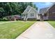 Attractive home with a green lawn and a long driveway, offering ample parking at 5111 Clearwater Rd, Charlotte, NC 28217