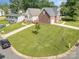 Charming home boasts lush lawn, complementing its brick and siding exteriors at 5111 Clearwater Rd, Charlotte, NC 28217