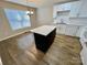 Eat-in kitchen featuring an island, white cabinets, and a window at 5111 Clearwater Rd, Charlotte, NC 28217