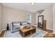 Cozy living room features hardwood floors, neutral paint, a comfortable sofa, and a stylish coffee table for relaxation at 5111 Clearwater Rd, Charlotte, NC 28217