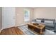 Cozy living room features hardwood floors, natural light from the window and a modern coffee table at 5111 Clearwater Rd, Charlotte, NC 28217