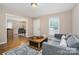 Inviting living room flows to the dining area, enhancing the home's open and airy appeal at 5111 Clearwater Rd, Charlotte, NC 28217