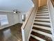 A staircase leading to the upper level, complemented by modern wooden treads and neutral walls at 5111 Clearwater Rd, Charlotte, NC 28217