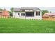 Spacious backyard with a lush lawn and a screened-in porch, perfect for entertaining at 5127 Lansing Dr, Charlotte, NC 28270