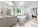 Bright bathroom with dual vanities, freestanding tub under window and stylish lighting creating a spa-like retreat at 5127 Lansing Dr, Charlotte, NC 28270