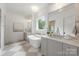 Elegant bathroom with a standalone tub, stylish vanity, and checkerboard floors creating a luxurious and relaxing atmosphere at 5127 Lansing Dr, Charlotte, NC 28270