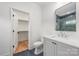 Modern bathroom featuring a walk-in shower, sleek vanity, and an open closet at 5127 Lansing Dr, Charlotte, NC 28270