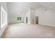 Spacious bedroom features a vaulted ceiling, neutral carpet, and ample natural light from large windows at 5127 Lansing Dr, Charlotte, NC 28270