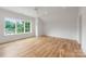 Spacious bedroom with hardwood floors and a large window with natural light and neutral walls at 5127 Lansing Dr, Charlotte, NC 28270