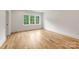 Bright, spacious bedroom with hardwood floors and large windows providing natural light at 5127 Lansing Dr, Charlotte, NC 28270