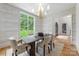 Elegant dining room with patterned wallpaper, window view, and contemporary chandelier at 5127 Lansing Dr, Charlotte, NC 28270