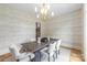 Elegant dining room with patterned wallpaper, chandelier lighting and natural light at 5127 Lansing Dr, Charlotte, NC 28270