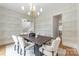 Elegant dining room with patterned wallpaper, chandelier lighting and natural light at 5127 Lansing Dr, Charlotte, NC 28270