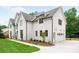 Elegant white brick home featuring manicured landscaping and a convenient attached garage at 5127 Lansing Dr, Charlotte, NC 28270