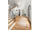Bright foyer with hardwood floors, chandelier lighting, staircase, and arched entry at 5127 Lansing Dr, Charlotte, NC 28270