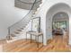Elegant foyer featuring a curved staircase with iron railings and a view into the open living space at 5127 Lansing Dr, Charlotte, NC 28270