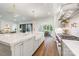 Bright kitchen features a large island with marble countertops, farmhouse sink, and stainless steel appliances at 5127 Lansing Dr, Charlotte, NC 28270