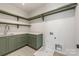 Well-equipped laundry room with green cabinetry, quartz countertop, and convenient shelving at 5127 Lansing Dr, Charlotte, NC 28270