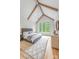Spacious bedroom with vaulted ceilings, exposed beams, large windows, and a luxurious rug creating a serene retreat at 5127 Lansing Dr, Charlotte, NC 28270