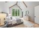 Bright main bedroom featuring vaulted ceiling, exposed beams, large windows and a chandelier, offering a peaceful ambiance at 5127 Lansing Dr, Charlotte, NC 28270