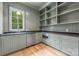Well-organized pantry has custom cabinets, shelving, dark countertops, stainless steel microwave and a window at 5127 Lansing Dr, Charlotte, NC 28270