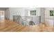 Modern staircase with black iron railing and natural light with hardwood floors overlooking entry at 5127 Lansing Dr, Charlotte, NC 28270