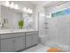 Modern bathroom featuring dual sinks, a large mirror, and a glass-enclosed tiled shower at 5481 Comiskey Aly, Kannapolis, NC 28081