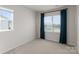 Empty bedroom with neutral carpet, a bright window with blinds and teal curtains at 5481 Comiskey Aly, Kannapolis, NC 28081