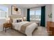 Bright bedroom featuring a large window, stylish decor, and a comfortable upholstered bed at 5481 Comiskey Aly, Kannapolis, NC 28081