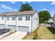 New construction townhome features a gray garage, modern trim, and well-kept landscaping at 5481 Comiskey Aly, Kannapolis, NC 28081