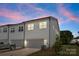 Modern two-story townhome featuring attached garages and contemporary design elements for convenient parking and stylish living at 5481 Comiskey Aly, Kannapolis, NC 28081