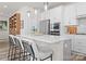 Bright, modern kitchen with white cabinets, stainless steel appliances, and a large quartz countertop island with seating at 5481 Comiskey Aly, Kannapolis, NC 28081