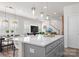 Modern kitchen with stainless steel appliances, a large island with seating, and an open layout to the dining and living areas at 5481 Comiskey Aly, Kannapolis, NC 28081
